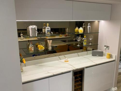 UV bonded shelfs onto mirrored splashback